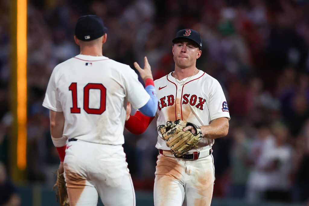 Jul 7, 2025; Boston, Massachusetts, USA; Boston Red Sox second baseman Romy Gonzalez (23) and shortstop Trevor Story (10) celebrate after defeating the Colorado Rockies at Fenway Park. Mandatory Credit: Paul Rutherford-Imagn Images