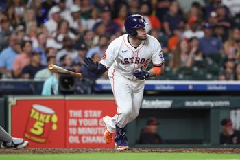 Jul 8, 2025; Houston, Texas, USA; Houston Astros first baseman Victor Caratini (17) drives in a run with a sacrifice fly during the fifth inning against the Cleveland Guardians at Daikin Park. Mandatory Credit: Troy Taormina-Imagn Images