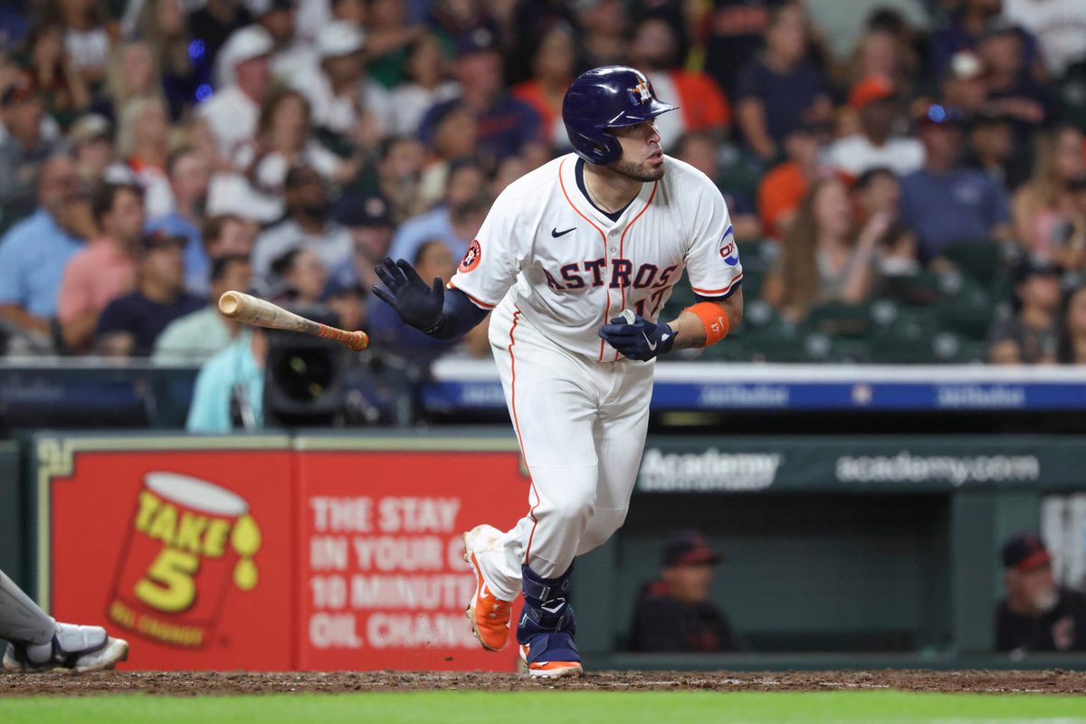 Jul 8, 2025; Houston, Texas, USA; Houston Astros first baseman Victor Caratini (17) drives in a run with a sacrifice fly during the fifth inning against the Cleveland Guardians at Daikin Park. Mandatory Credit: Troy Taormina-Imagn Images