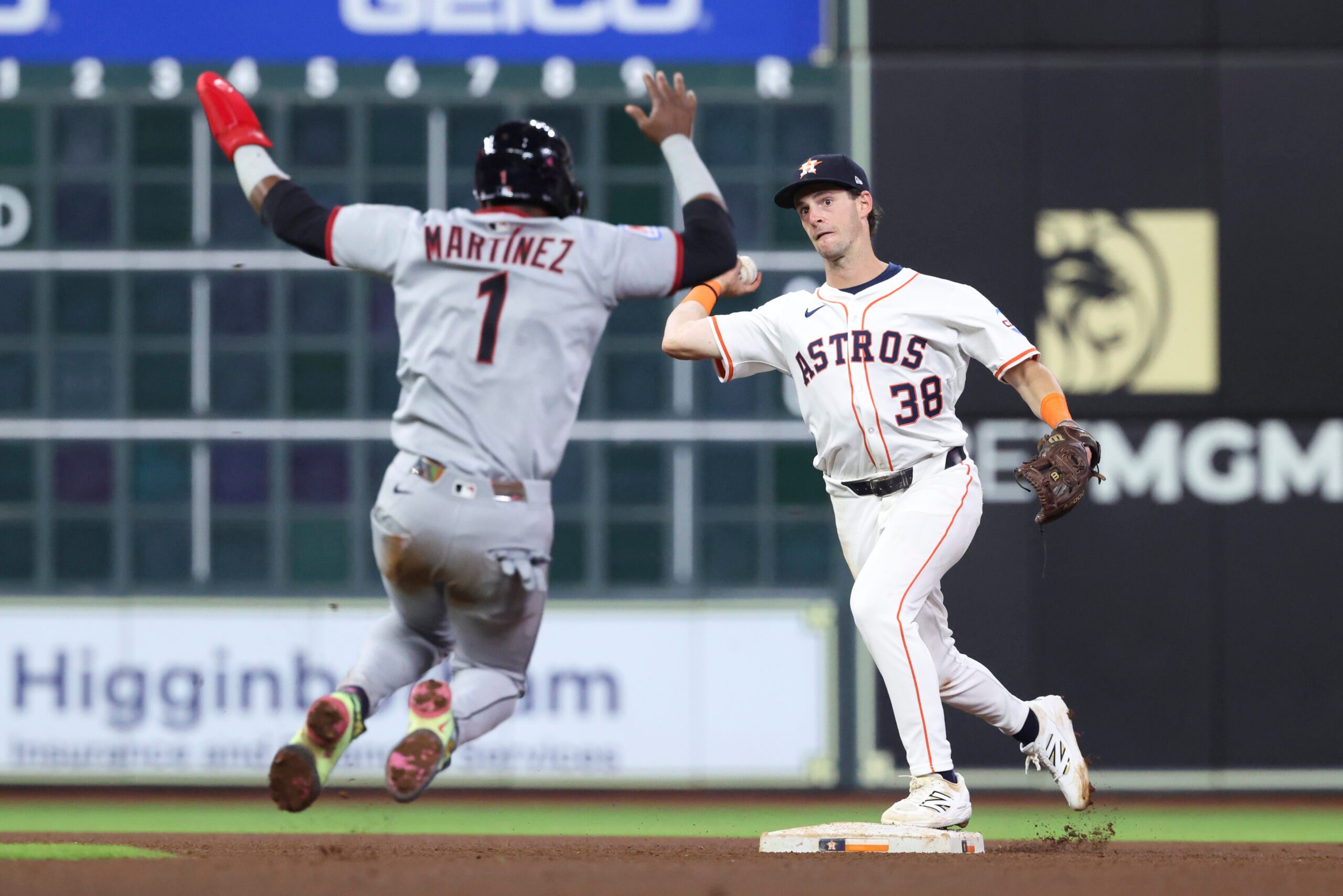 Jul 8, 2025; Houston, Texas, USA; Cleveland Guardians second baseman Angel Martinez (1) is out and Houston Astros shortstop Zack Short (38) throws to first base for a double play during the sixth inning at Daikin Park. Mandatory Credit: Troy Taormina-Imagn Images