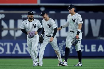 Jul 8, 2025; Bronx, New York, USA; New York Yankees left fielder Jasson Dominguez (24) and center fielder Cody Bellinger (35) and right fielder Aaron Judge (99) celebrate after defeating the Seattle Mariners at Yankee Stadium. Mandatory Credit: Brad Penner-Imagn Images