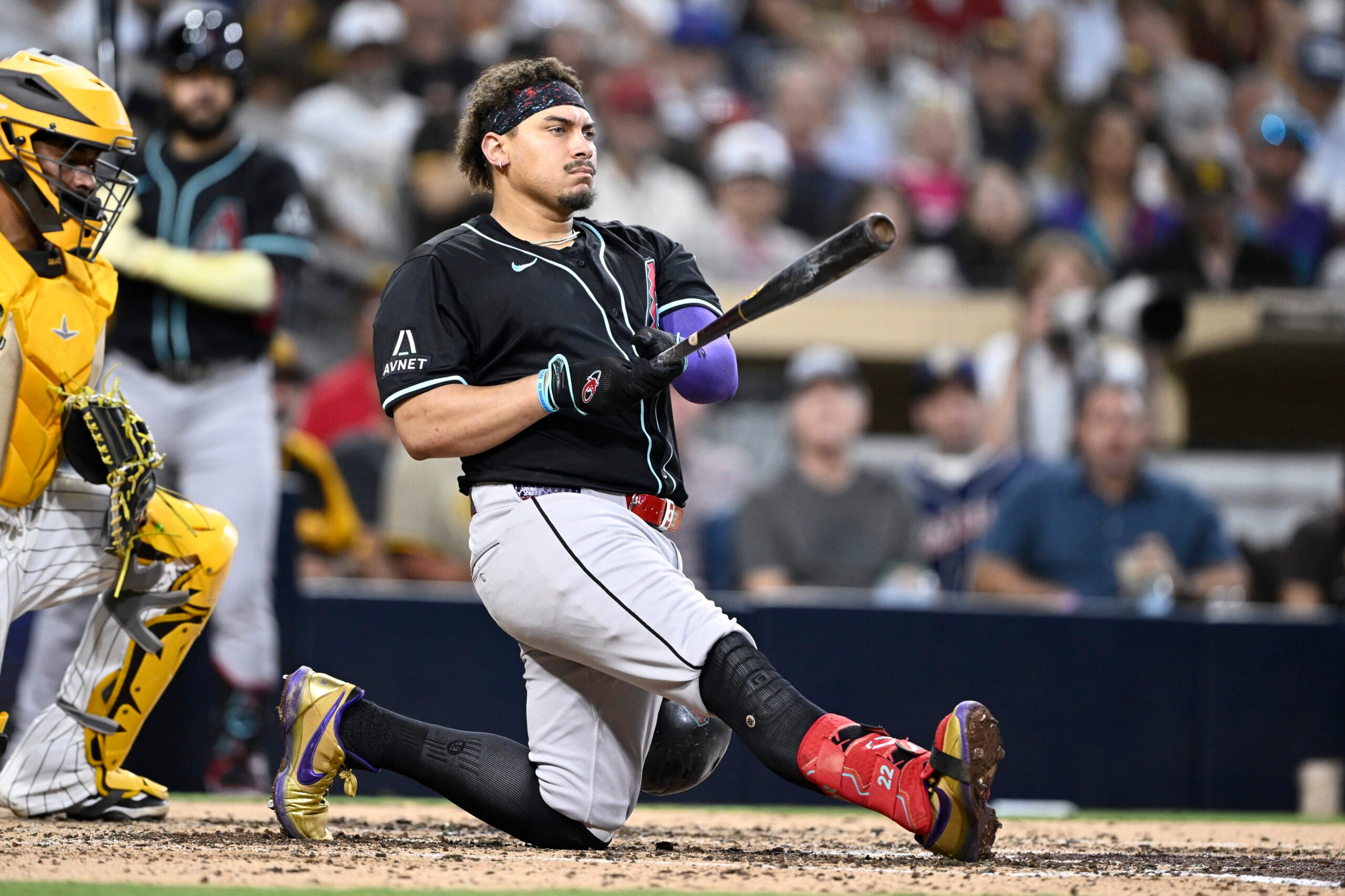 Jul 8, 2025; San Diego, California, USA; Arizona Diamondbacks first baseman Josh Naylor (22) loses his helmet as he takes a strike during the sixth inning against the San Diego Padres at Petco Park. Mandatory Credit: Denis Poroy-Imagn Images