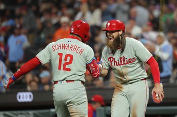 Jul 8, 2025; San Francisco, California, USA; Philadelphia Phillies designated hitter Kyle Schwarber (12) celebrates with pinch hitter outfielder Brandon Marsh (16) after batting him in on a two-run home run against the San Francisco Giants during the seventh inning at Oracle Park. Mandatory Credit: Kelley L Cox-Imagn Images