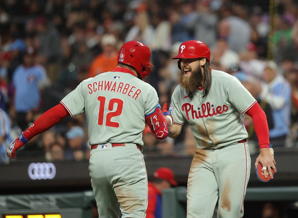 Jul 8, 2025; San Francisco, California, USA; Philadelphia Phillies designated hitter Kyle Schwarber (12) celebrates with pinch hitter outfielder Brandon Marsh (16) after batting him in on a two-run home run against the San Francisco Giants during the seventh inning at Oracle Park. Mandatory Credit: Kelley L Cox-Imagn Images