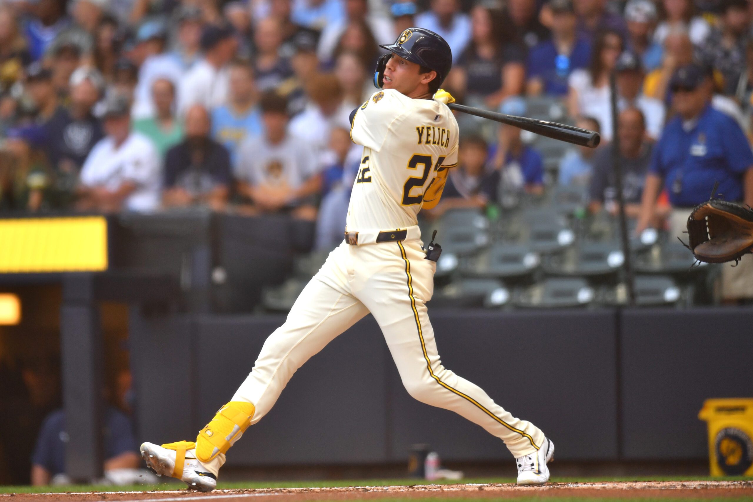 Jul 9, 2025; Milwaukee, Wisconsin, USA; Milwaukee Brewers designated hitter Christian Yelich (22) hits a single during the second inning against the Los Angeles Dodgers at American Family Field. Mandatory Credit: Patrick Gorski-Imagn Images