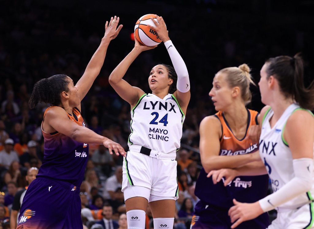 Jul 9, 2025; Phoenix, Arizona, USA; Minnesota Lynx forward Napheesa Collier (24) shoots the ball against Phoenix Mercury forward Alyssa Thomas (25)during the second half at PHX Arena. Mandatory Credit: Mark J. Rebilas-Imagn Images
