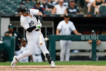 Jul 9, 2025; Chicago, Illinois, USA; Chicago White Sox third baseman Miguel Vargas (20) singles against the Toronto Blue Jays during the eight inning at Rate Field. Mandatory Credit: Kamil Krzaczynski-Imagn Images