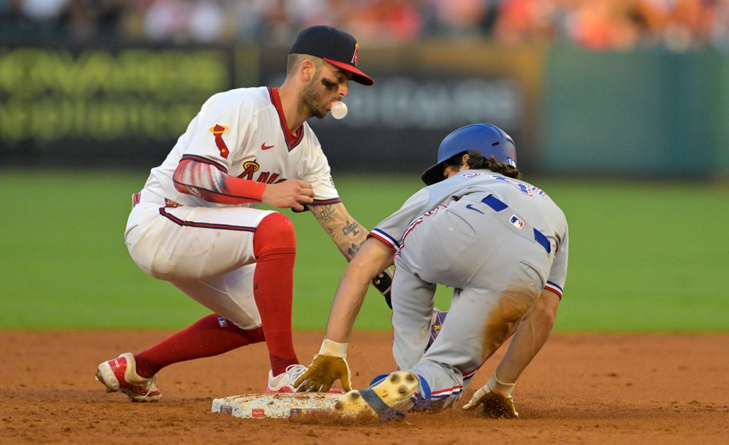 Jul 9, 2025; Anaheim, California, USA; Texas Rangers shortstop Josh Smith (8) beats the tag by Los Angeles Angels shortstop Zach Neto (9) for a stolen base in the fourth inning at Angel Stadium. Mandatory Credit: Jayne Kamin-Oncea-Imagn Images