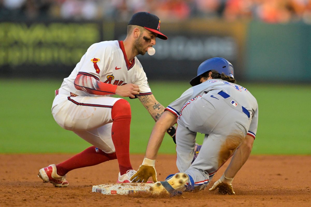 Jul 9, 2025; Anaheim, California, USA; Texas Rangers shortstop Josh Smith (8) beats the tag by Los Angeles Angels shortstop Zach Neto (9) for a stolen base in the fourth inning at Angel Stadium. Mandatory Credit: Jayne Kamin-Oncea-Imagn Images