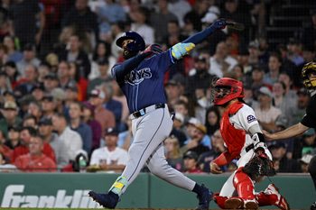 Jul 10, 2025; Boston, Massachusetts, USA; Tampa Bay Rays third baseman Junior Caminero (13) hits a home run against the Boston Red Sox during the sixth inning at Fenway Park. Mandatory Credit: Eric Canha-Imagn Images
