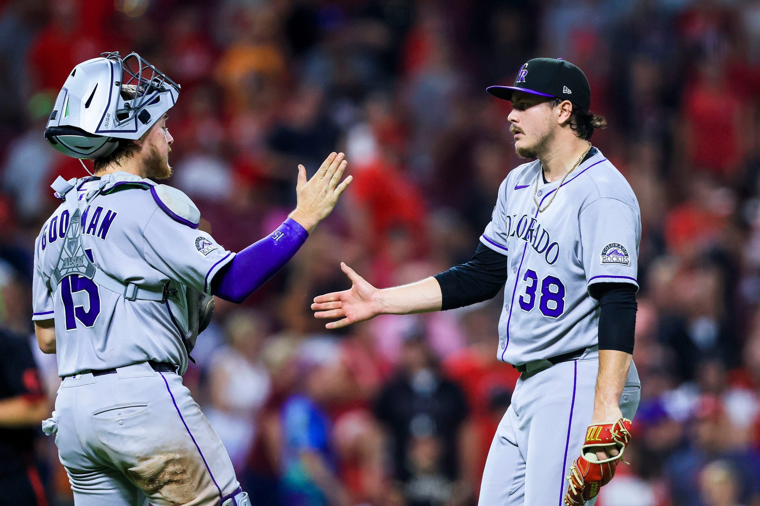 Jul 11, 2025; Cincinnati, Ohio, USA; Colorado Rockies catcher Hunter Goodman (15) high fives relief pitcher Victor Vodnik (38) after the victory over the Cincinnati Reds at Great American Ball Park. Mandatory Credit: Katie Stratman-Imagn Images