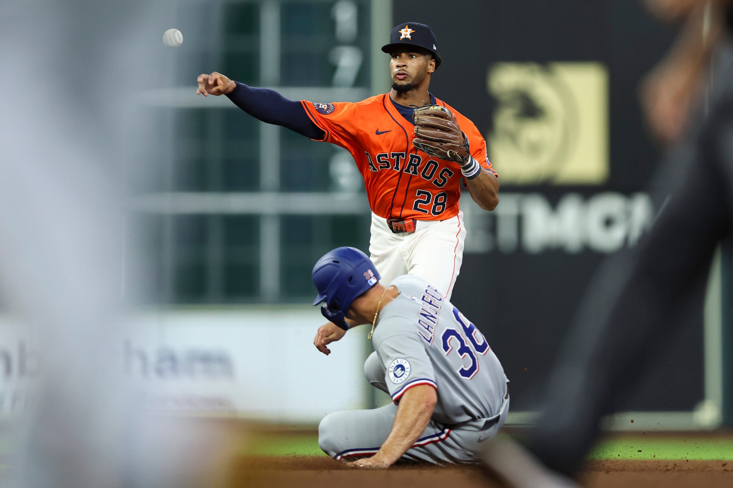 Jul 11, 2025; Houston, Texas, USA; Texas Rangers left fielder Wyatt Langford (36) is out at second base and Houston Astros second baseman Brice Matthews (28) throws to first base to complete a double play during the fifth inning at Daikin Park. Mandatory Credit: Troy Taormina-Imagn Images