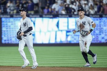 Jul 11, 2025; Bronx, New York, USA;  New York Yankees center fielder Cody Bellinger (35) and right fielder Aaron Judge (99) walk off the field after defeating the Chicago Cubs 11-0 at Yankee Stadium. Mandatory Credit: Wendell Cruz-Imagn Images