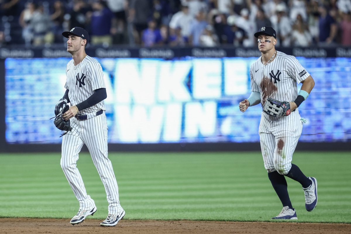 Jul 11, 2025; Bronx, New York, USA; New York Yankees center fielder Cody Bellinger (35) and right fielder Aaron Judge (99) walk off the field after defeating the Chicago Cubs 11-0 at Yankee Stadium. Mandatory Credit: Wendell Cruz-Imagn Images