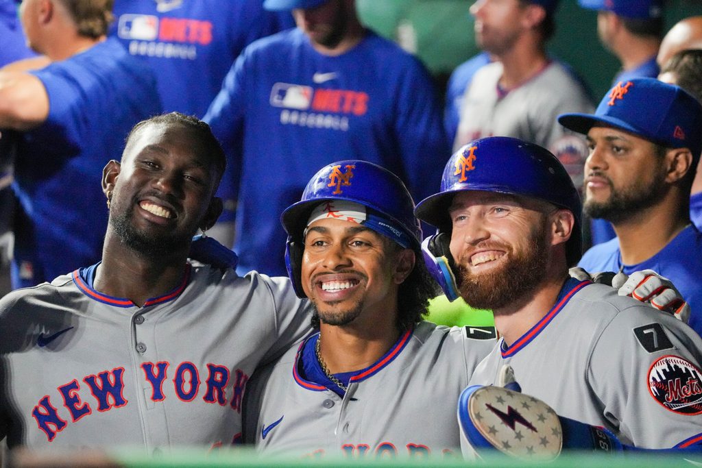Jul 11, 2025; Kansas City, Missouri, USA; New York Mets third baseman Ronny Mauricio (10) and shortstop Francisco Lindor (12) and left fielder Brandon Nimmo (9) pose for a photo after scoring against the Kansas City Royals in the ninth inning at Kauffman Stadium. Mandatory Credit: Denny Medley-Imagn Images