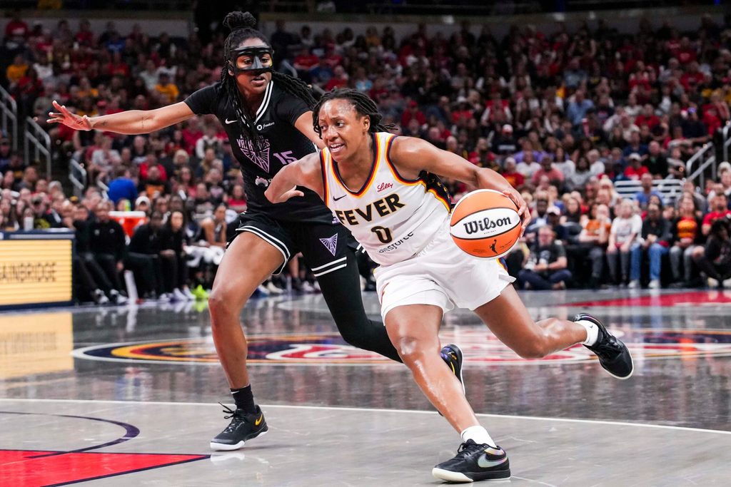 Indiana Fever guard Kelsey Mitchell (0) drives to the basket against Golden State Valkyries guard Tiffany Hayes (15) on Wednesday, July 9, 2025, during a game between the Indiana Fever and the Golden State Valkyries at Gainbridge Fieldhouse in Indianapolis. The Golden State Valkyries defeated the Indiana Fever, 80-61.