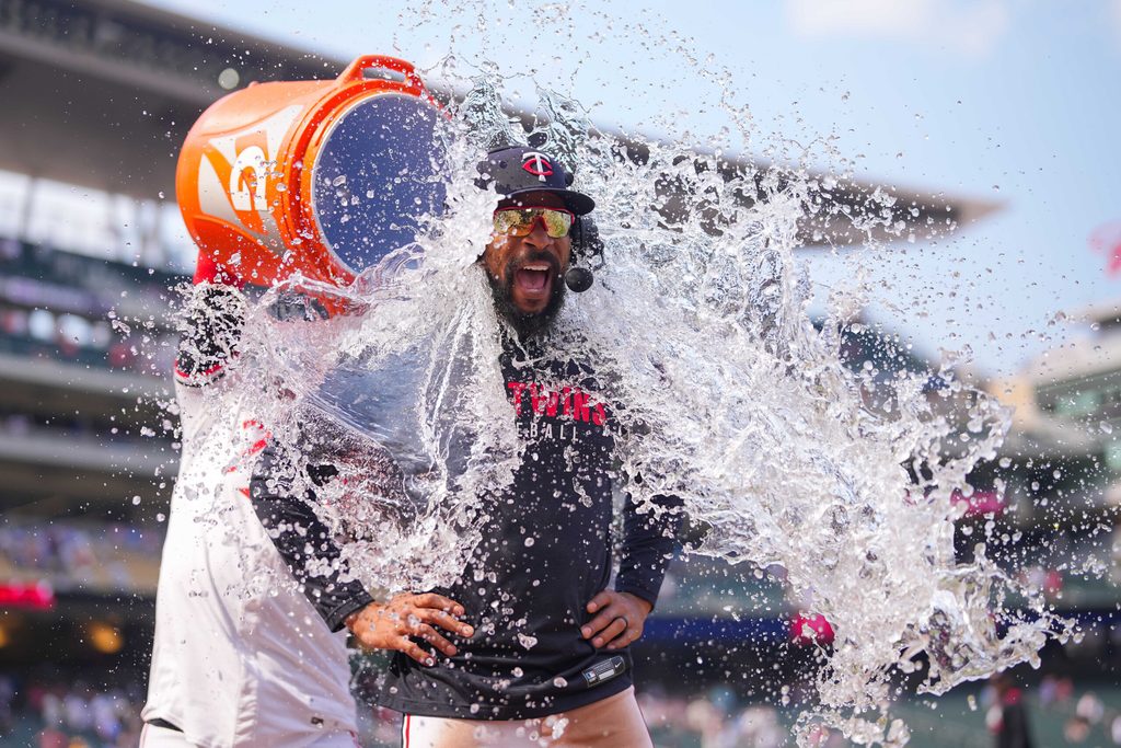 Jul 12, 2025; Minneapolis, Minnesota, USA; Minnesota Twins outfielder Byron Buxton (25) has water dumped on him after hitting for the cycle after the game against the Pittsburgh Pirates at Target Field. Mandatory Credit: Brad Rempel-Imagn Images