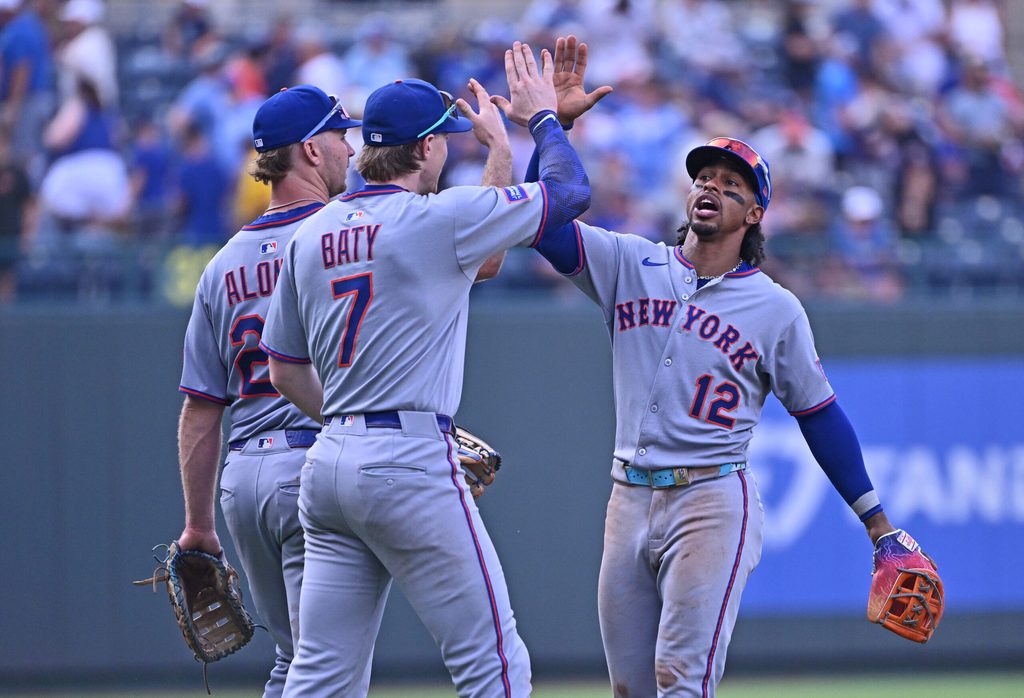 Jul 12, 2025; Kansas City, Missouri, USA; New York Mets shortstop Francisco Lindor (12) celebrates with teammates second baseman Brett Baty (7) and first baseman Pete Alonso (20) after beating the Kansas City Royals at Kauffman Stadium. Mandatory Credit: Peter Aiken-Imagn Images