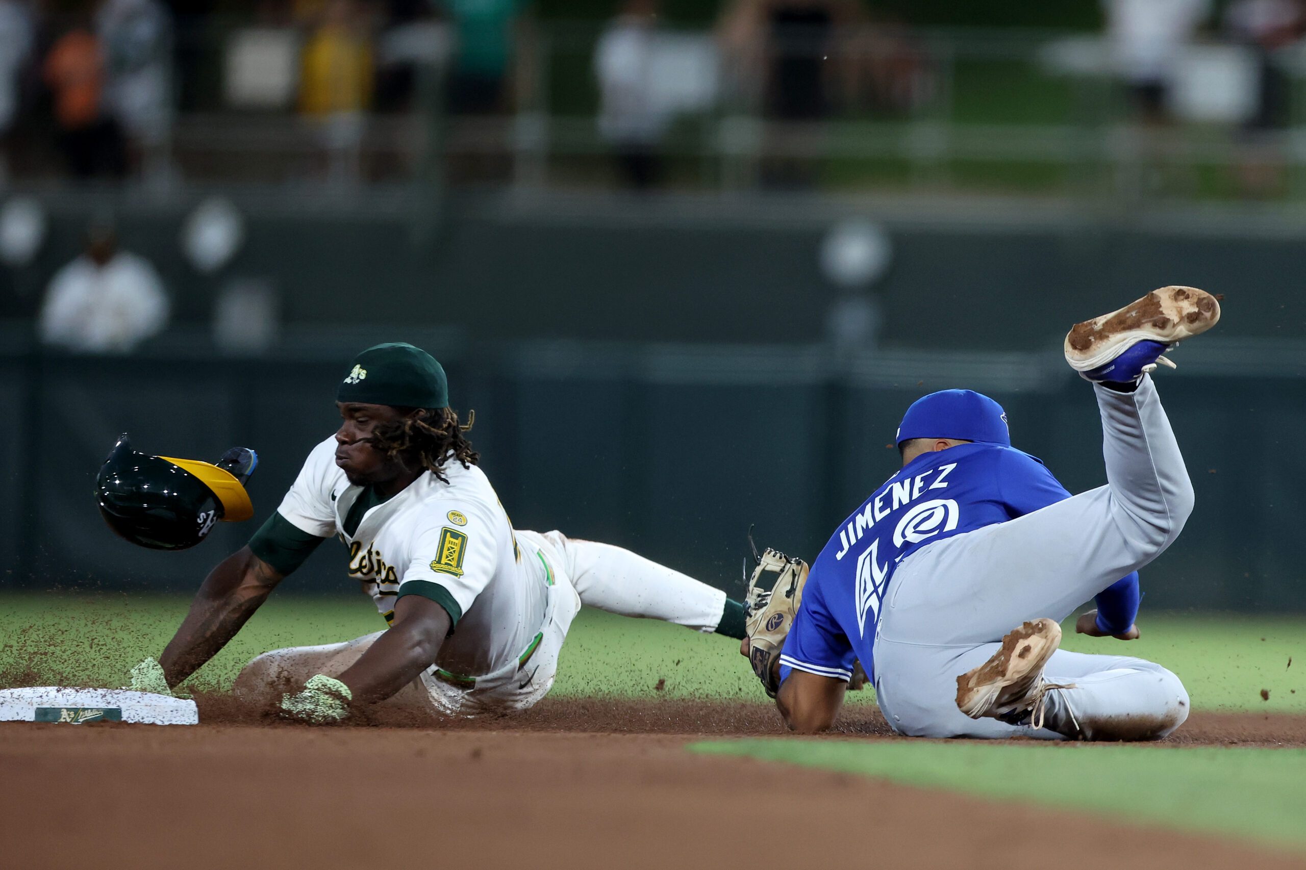 Jul 12, 2025; West Sacramento, California, USA; Athletics right fielder Lawrence Butler (4) is tagged out by Toronto Blue Jays second baseman Leo Jimenez (49) on a steal attempt during the fifth inning  at Sutter Health Park. Mandatory Credit: Dennis Lee-Imagn Images