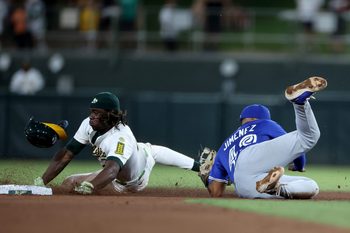 Jul 12, 2025; West Sacramento, California, USA; Athletics right fielder Lawrence Butler (4) is tagged out by Toronto Blue Jays second baseman Leo Jimenez (49) on a steal attempt during the fifth inning  at Sutter Health Park. Mandatory Credit: Dennis Lee-Imagn Images