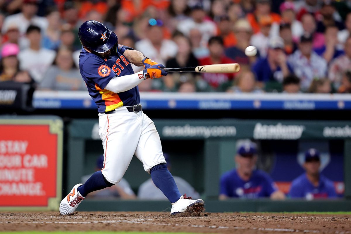 Jul 13, 2025; Houston, Texas, USA; Houston Astros second baseman Jose Altuve (27) hits a single against the Texas Rangers during the sixth inning at Daikin Park. Mandatory Credit: Erik Williams-Imagn Images