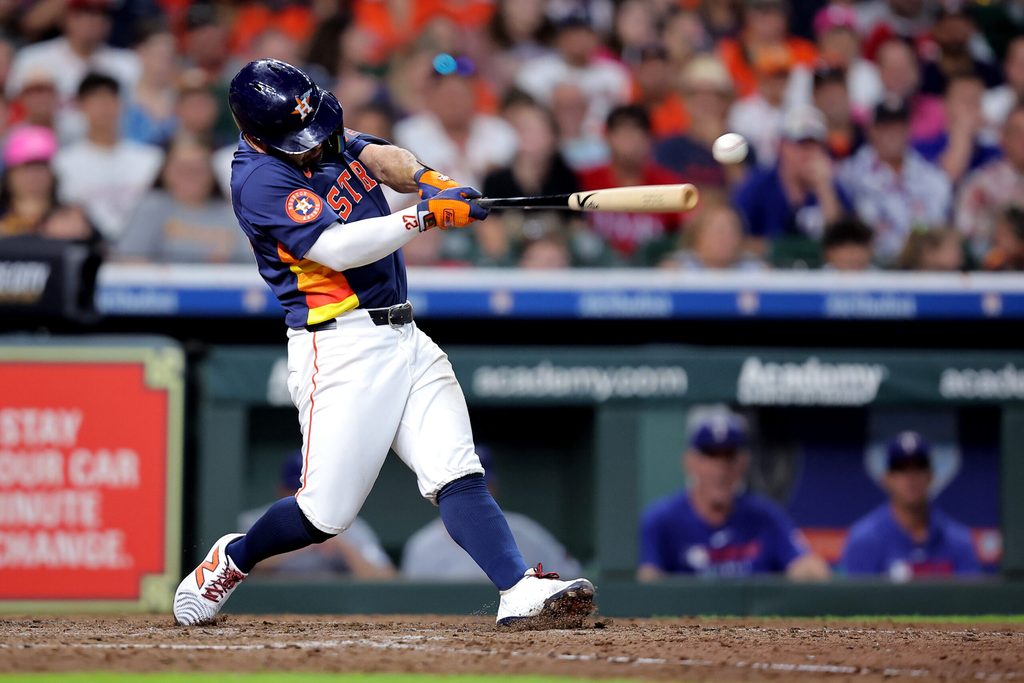Jul 13, 2025; Houston, Texas, USA; Houston Astros second baseman Jose Altuve (27) hits a single against the Texas Rangers during the sixth inning at Daikin Park. Mandatory Credit: Erik Williams-Imagn Images