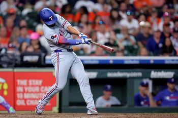 Jul 13, 2025; Houston, Texas, USA; Texas Rangers second baseman Marcus Semien (2) hits a home run to left field against the Houston Astros during the eighth inning at Daikin Park. Mandatory Credit: Erik Williams-Imagn Images