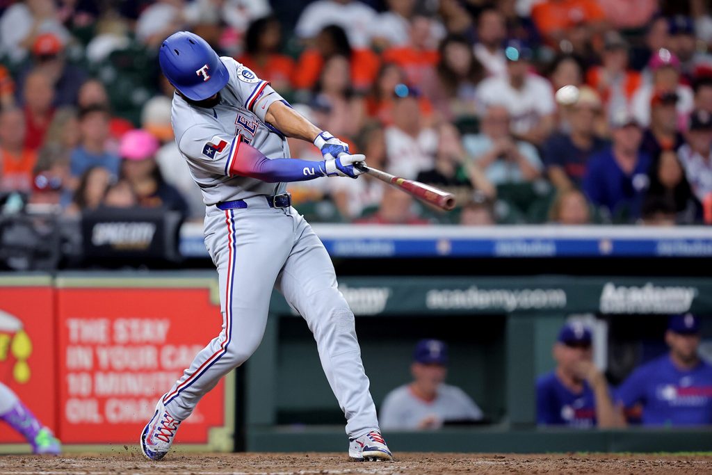Jul 13, 2025; Houston, Texas, USA; Texas Rangers second baseman Marcus Semien (2) hits a home run to left field against the Houston Astros during the eighth inning at Daikin Park. Mandatory Credit: Erik Williams-Imagn Images