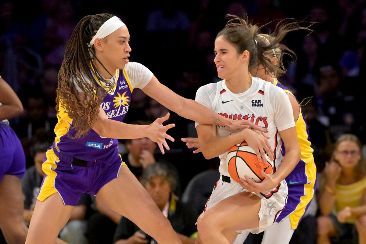 Jul 15, 2025; Los Angeles, California, USA; Los Angeles Los Angeles Sparks forward Dearica Hamby (5) reaches in for the ball controlled by Washington Mystics forward Emily Engstler (21) during the first half at Crypto.com Arena. Mandatory Credit: Jayne Kamin-Oncea-Imagn Images