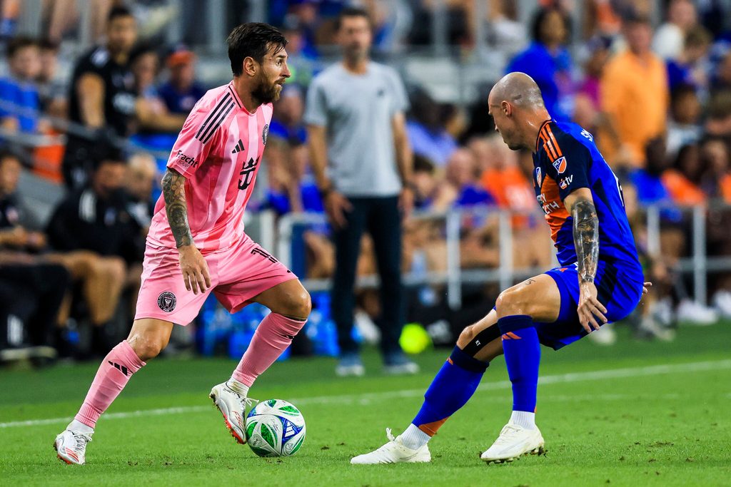 Jul 16, 2025; Cincinnati, Ohio, USA; Inter Miami CF forward Lionel Messi (10) dribbles against FC Cincinnati defender Brad Smith (14) in the second half at TQL Stadium. Mandatory Credit: Katie Stratman-Imagn Images