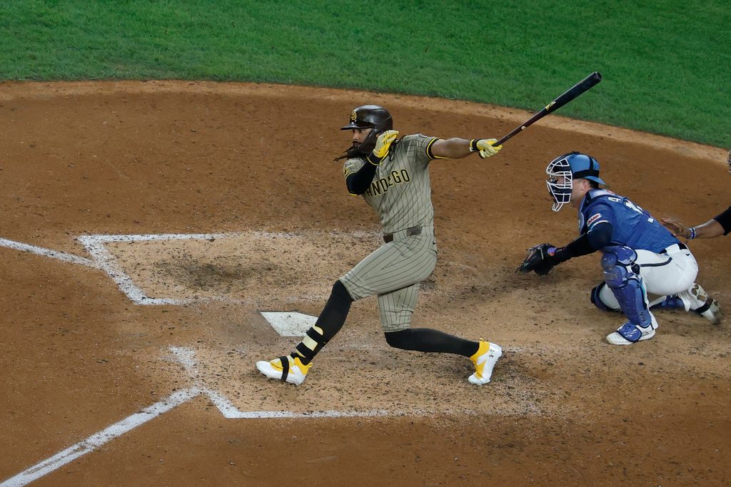 Jul 18, 2025; Washington, District of Columbia, USA; San Diego Padres outfielder Fernando Tatis Jr. (23) singles against the Washington Nationals during the ninth inning at Nationals Park. Mandatory Credit: Geoff Burke-Imagn Images