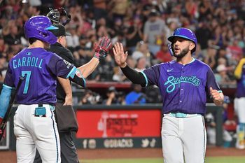 Jul 18, 2025; Phoenix, Arizona, USA; Arizona Diamondbacks catcher Adrian Del Castillo (25) celebrates with outfielder Corbin Carroll (7) after scoring in the second inning against the St. Louis Cardinals at Chase Field. Mandatory Credit: Matt Kartozian-Imagn Images