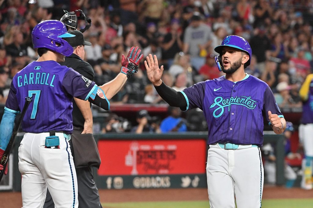 Jul 18, 2025; Phoenix, Arizona, USA; Arizona Diamondbacks catcher Adrian Del Castillo (25) celebrates with outfielder Corbin Carroll (7) after scoring in the second inning against the St. Louis Cardinals at Chase Field. Mandatory Credit: Matt Kartozian-Imagn Images