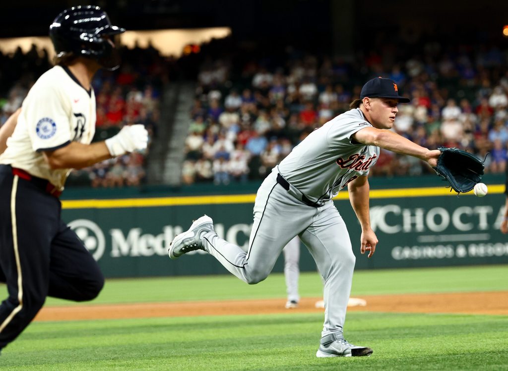 Jul 18, 2025; Arlington, Texas, USA;  Detroit Tigers relief pitcher Tyler Holton (87) pitches the ball to first base to get Texas Rangers third baseman Josh Smith (8) out during the sixth inning at Globe Life Field. Mandatory Credit: Kevin Jairaj-Imagn Images