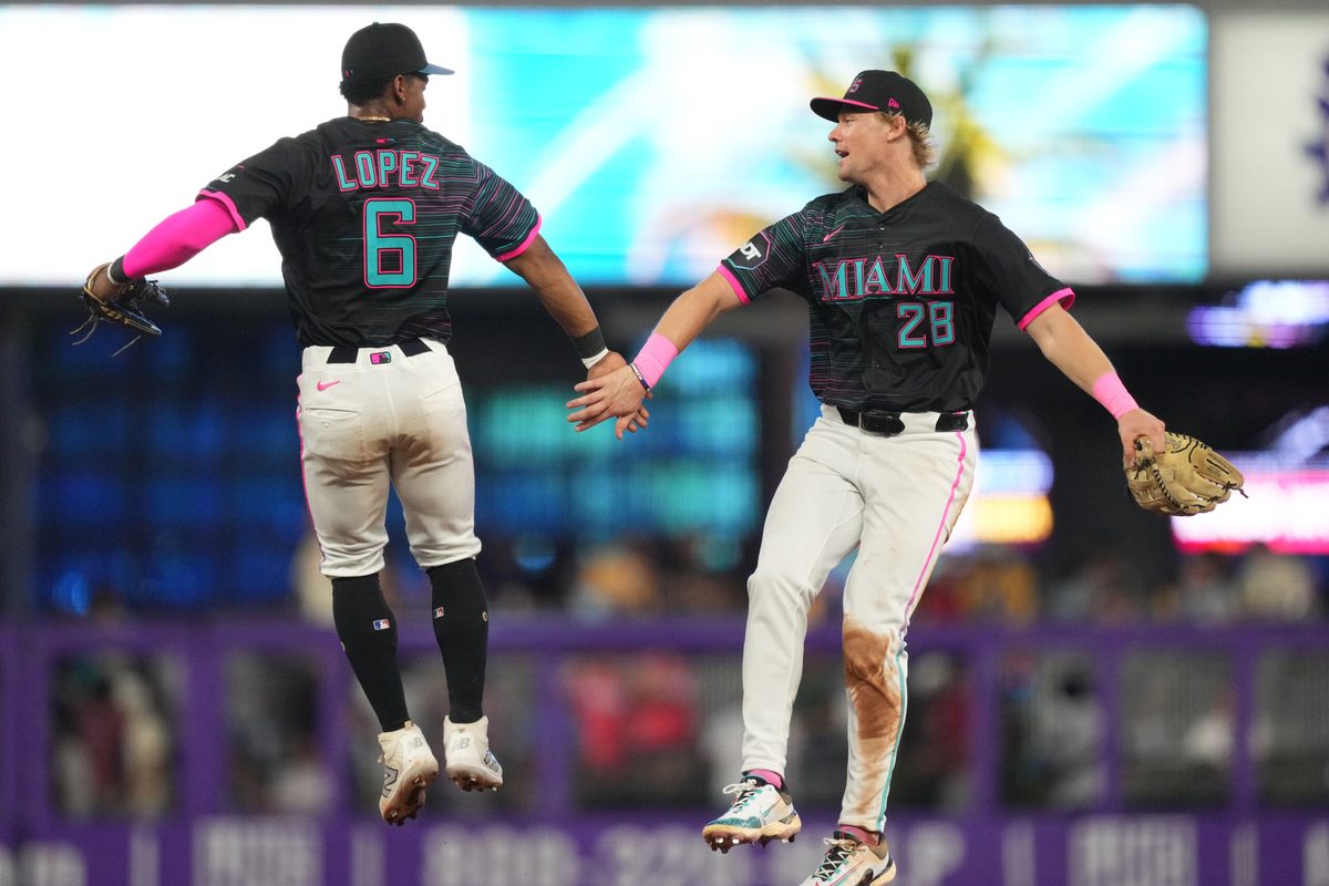 Jul 19, 2025; Miami, Florida, USA; Miami Marlins left fielder Kyle Stowers (28) and shortstop Otto Lopez (6) celebrate a victory against the Kansas City Royals at loanDepot Park. Mandatory Credit: Jim Rassol-Imagn Images