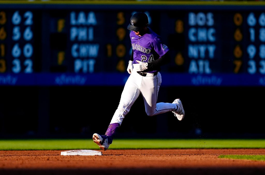 Jul 19, 2025; Denver, Colorado, USA; Colorado Rockies third base Ryan McMahon (24) runs off a two-run home run in the third inning against the Minnesota Twins at Coors Field. Mandatory Credit: Ron Chenoy-Imagn Images