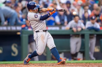 Jul 19, 2025; Seattle, Washington, USA;  Houston Astros left fielder Jose Altuve (27) hits a double during the fifth inning against the Seattle Mariners  at T-Mobile Park. Mandatory Credit: Stephen Brashear-Imagn Images