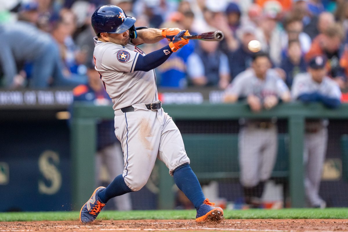 Jul 19, 2025; Seattle, Washington, USA; Houston Astros left fielder Jose Altuve (27) hits a double during the fifth inning against the Seattle Mariners at T-Mobile Park. Mandatory Credit: Stephen Brashear-Imagn Images
