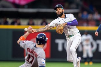 Jul 19, 2025; Seattle, Washington, USA;  Seattle Mariners shortstop J.P. Crawford (3) turns a double play after forcing out Houston Astros right fielder Cam Smith (11) at second base during the fifth inning at T-Mobile Park. Mandatory Credit: Stephen Brashear-Imagn Images