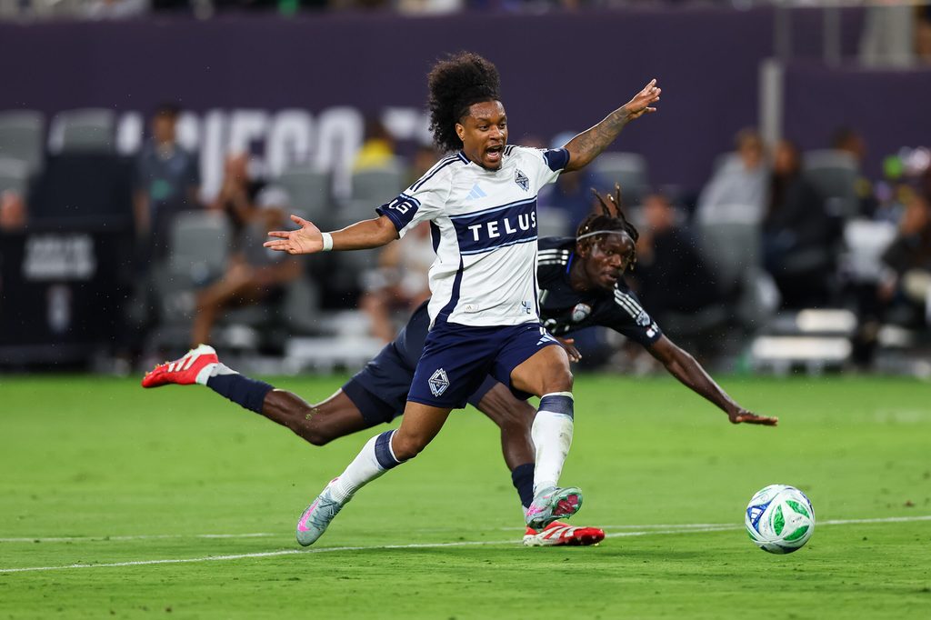Jul 19, 2025; San Diego, California, USA; Vancouver Whitecaps forward Jayden Nelson (7) gets tripped up with San Diego FC midfielder Manu Duah (26) during the second half at Snapdragon Stadium. Mandatory Credit: Chadd Cady-Imagn Images