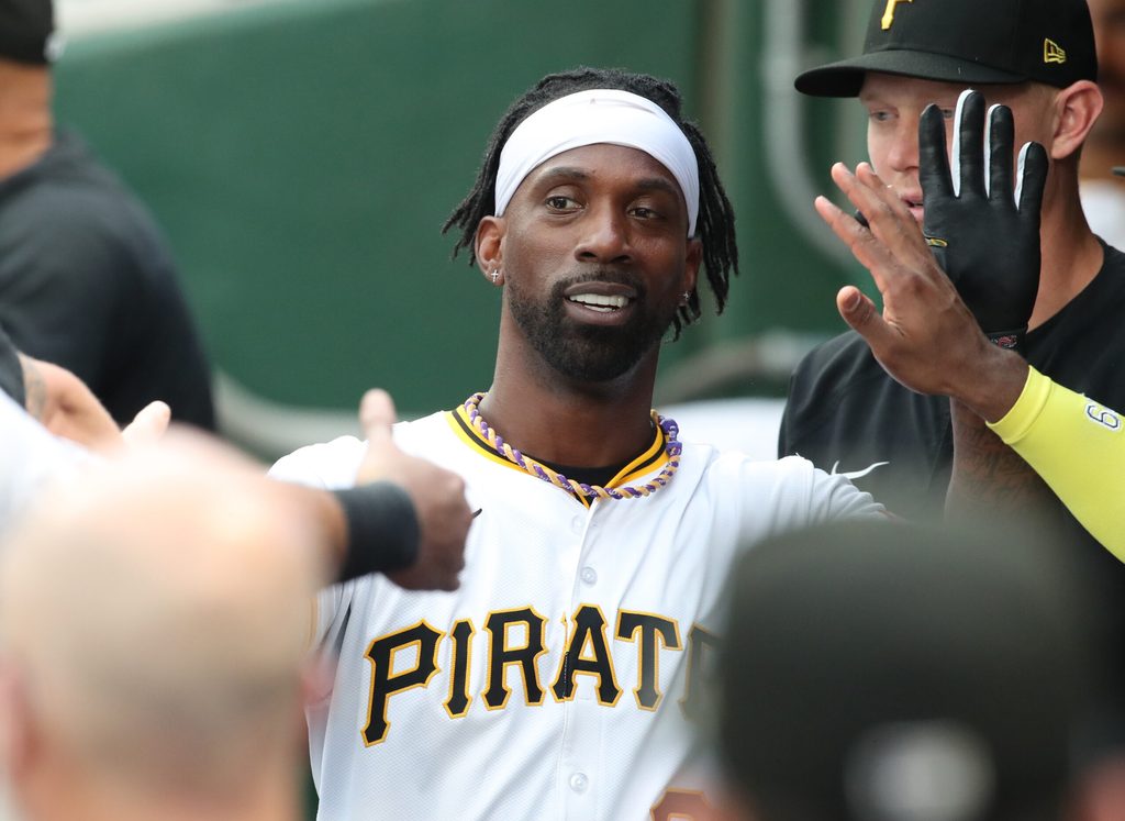 Jul 20, 2025; Pittsburgh, Pennsylvania, USA; Pittsburgh Pirates designated hitter Andrew McCutchen (22) high-fives in the dugout after scoring a run against the Chicago White Sox at PNC Park. Mandatory Credit: Charles LeClaire-Imagn Images