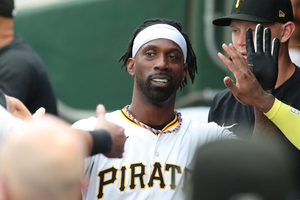 Jul 20, 2025; Pittsburgh, Pennsylvania, USA; Pittsburgh Pirates designated hitter Andrew McCutchen (22) high-fives in the dugout after scoring a run against the Chicago White Sox at PNC Park. Mandatory Credit: Charles LeClaire-Imagn Images