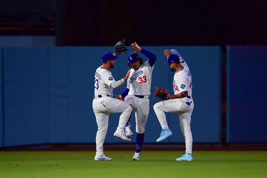 Jul 21, 2025; Los Angeles, California, USA; Los Angeles Dodgers left fielder Michael Conforto (23) outfielder James Outman (33) and center fielder Andy Pages (44) celebrate the victory against the Minnesota Twins at Dodger Stadium. Mandatory Credit: Gary A. Vasquez-Imagn Images