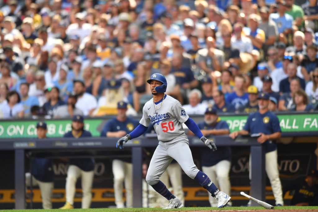 Jul 9, 2025; Milwaukee, Wisconsin, USA; Los Angeles Dodgers shortstop Mookie Betts (50) watches his sacrifice fly RBI during the seventh inning against the Milwaukee Brewers at American Family Field. Mandatory Credit: Patrick Gorski-Imagn Images