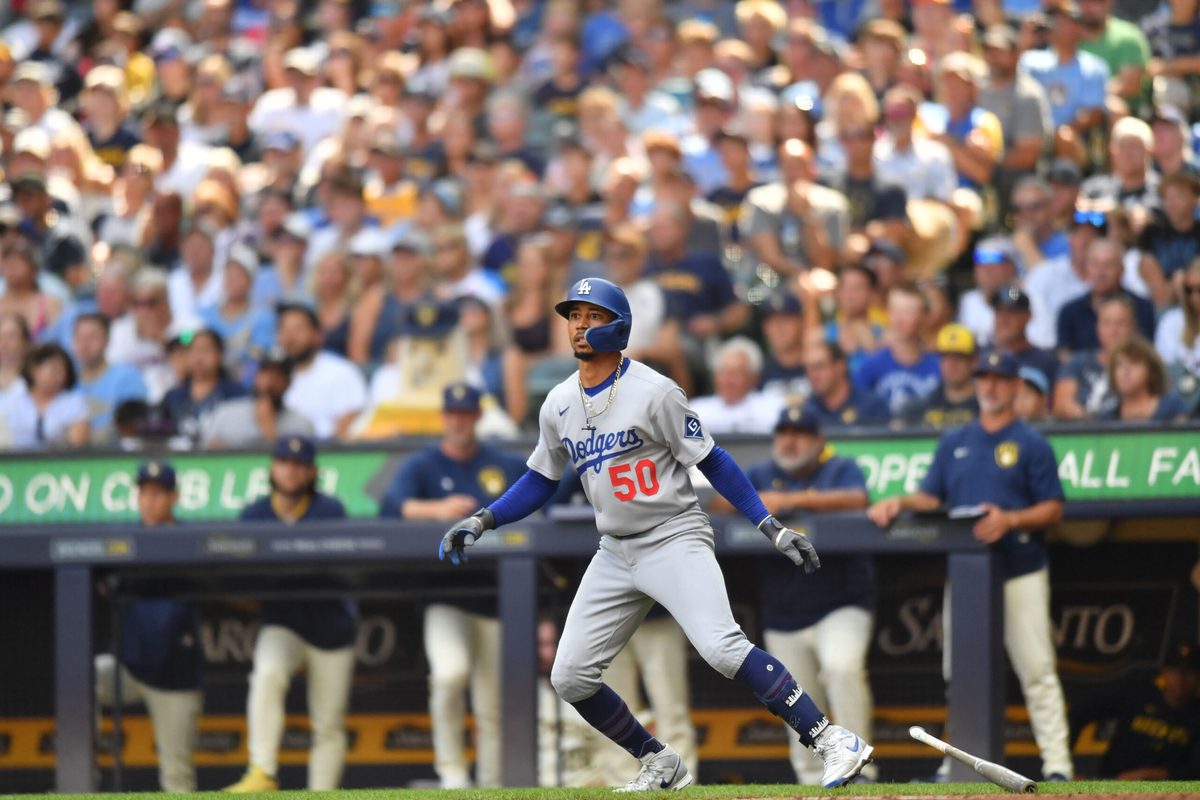 Jul 9, 2025; Milwaukee, Wisconsin, USA; Los Angeles Dodgers shortstop Mookie Betts (50) watches his sacrifice fly RBI during the seventh inning against the Milwaukee Brewers at American Family Field. Mandatory Credit: Patrick Gorski-Imagn Images