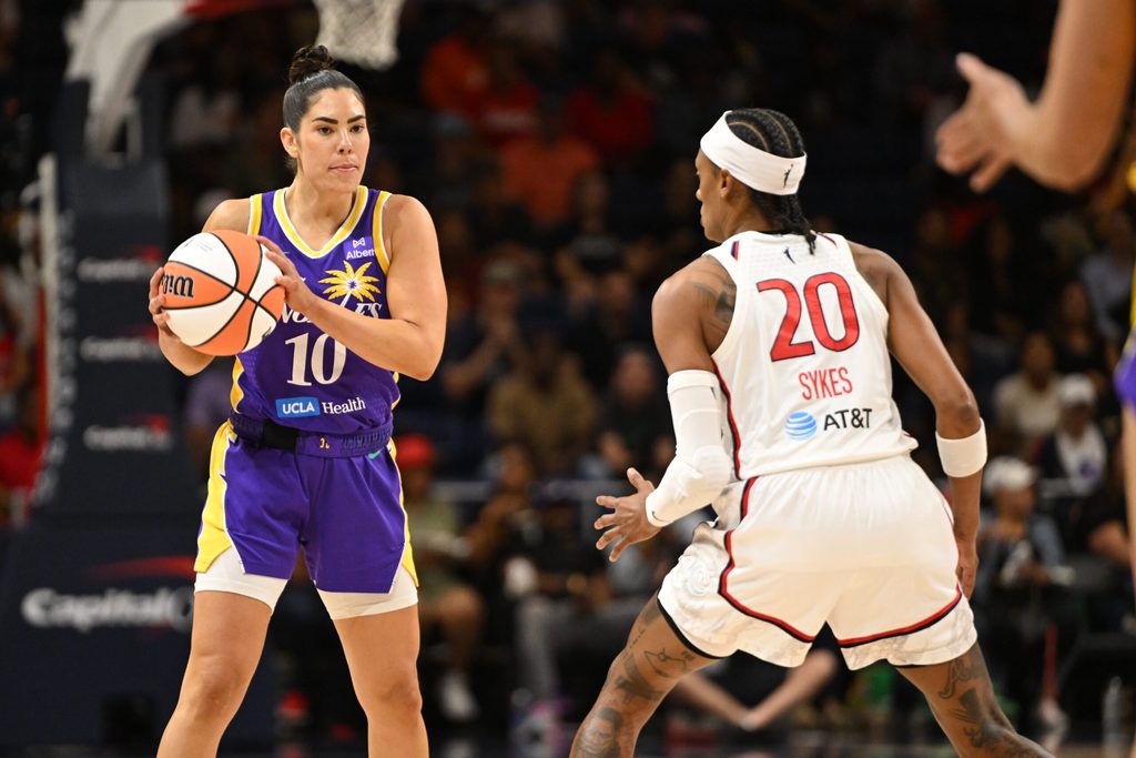 Jul 22, 2025; Washington, District of Columbia, USA; Los Angeles Sparks guard Kelsey Plum (10) looks to pass the ball in front of Washington Mystics guard Brittney Sykes (20) during the first quarter at CareFirst Arena. Mandatory Credit: Rafael Suanes-Imagn Images