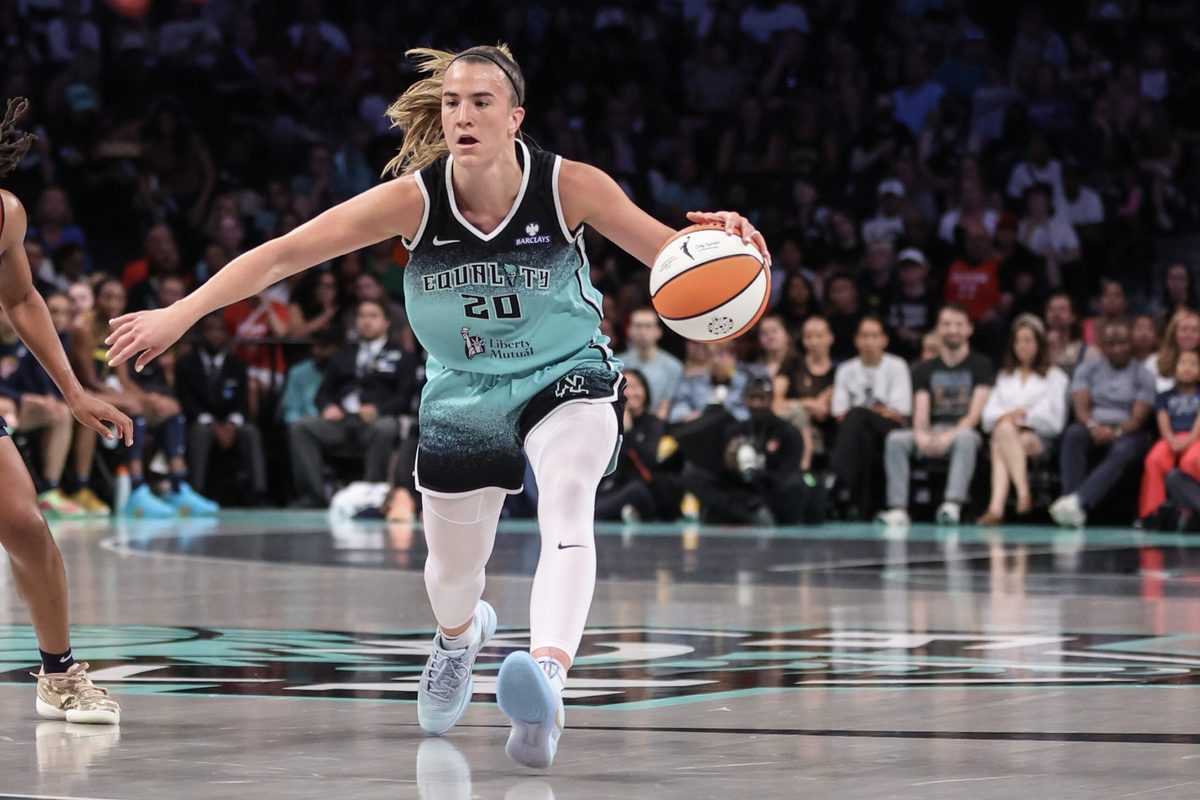 Jul 22, 2025; Brooklyn, New York, USA; New York Liberty guard Sabrina Ionescu (20) brings the ball up court in the first quarter against the Indiana Fever at Barclays Center. Mandatory Credit: Wendell Cruz-Imagn Images