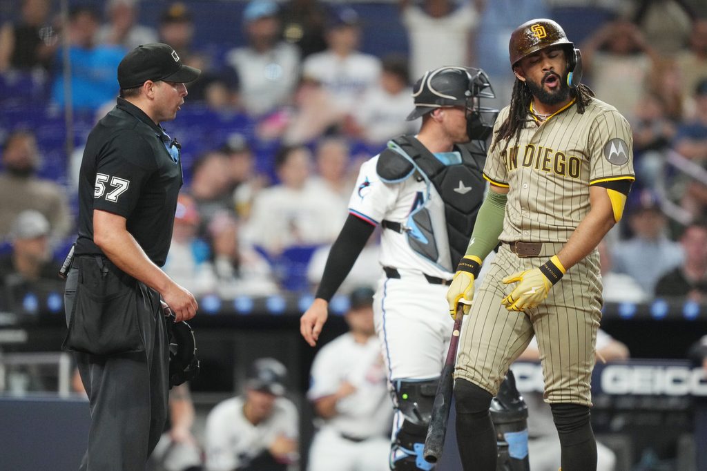 Jul 22, 2025; Miami, Florida, USA;  San Diego Padres right fielder Fernando Tatis Jr. (23) disputes the third strike call of umpire Paul Clemons (57) in the eighth inning at loanDepot Park. Mandatory Credit: Jim Rassol-Imagn Images
