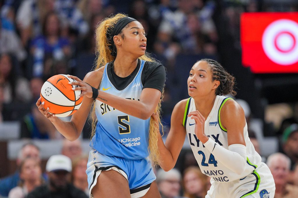 Jul 22, 2025; Minneapolis, Minnesota, USA; Minnesota Lynx forward Napheesa Collier (24) defends Chicago Sky forward Angel Reese (5) in the fourth quarter at Target Center. Mandatory Credit: Brad Rempel-Imagn Images