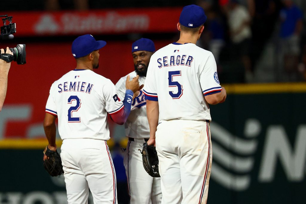 Jul 22, 2025; Arlington, Texas, USA; Texas Rangers shortstop Corey Seager (5) celebrates with Texas Rangers second baseman Marcus Semien (2) and Texas Rangers right fielder Adolis Garcia (53) after the game against the Athletics at Globe Life Field. Mandatory Credit: Kevin Jairaj-Imagn Images